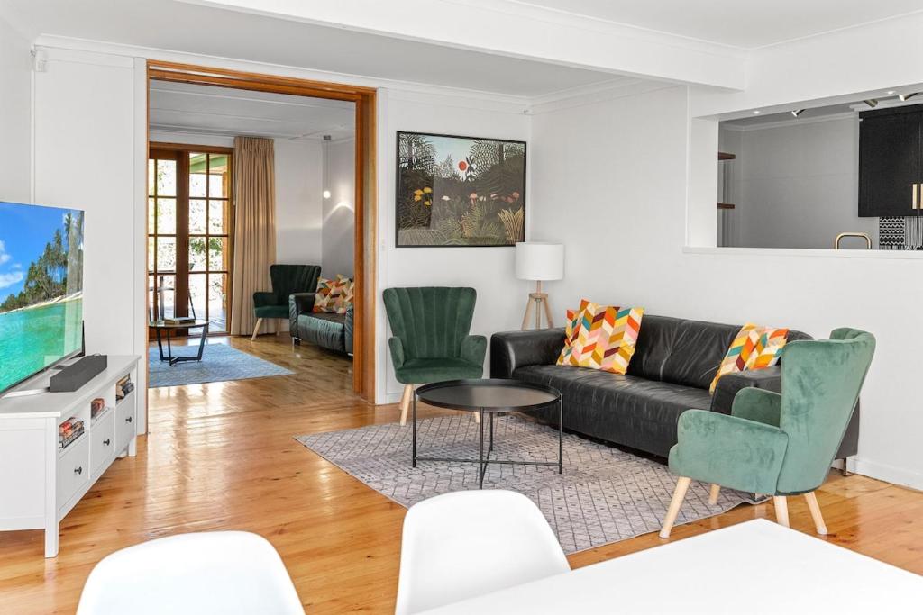 a living room with a couch and a table and chairs at Gated & Secure Single-Level Home in CBD in Turner