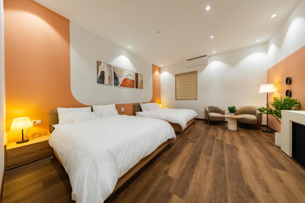 a bedroom with two beds and a fireplace at Nesta Home - Old Street in Hanoi