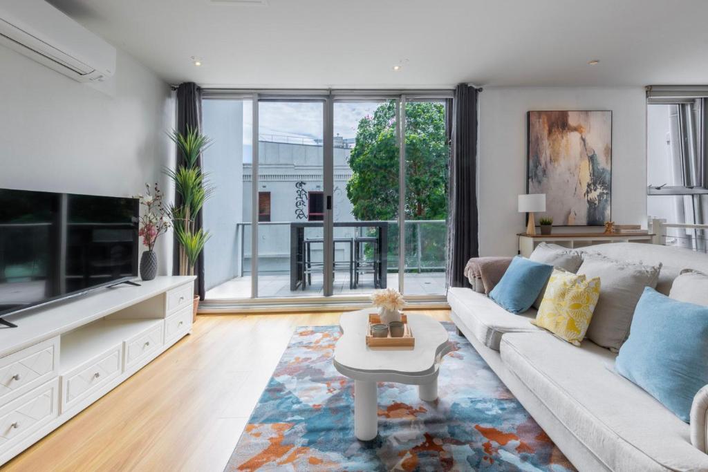 a living room with a couch and a table at Comfortable Loft Living in Footscray in Melbourne