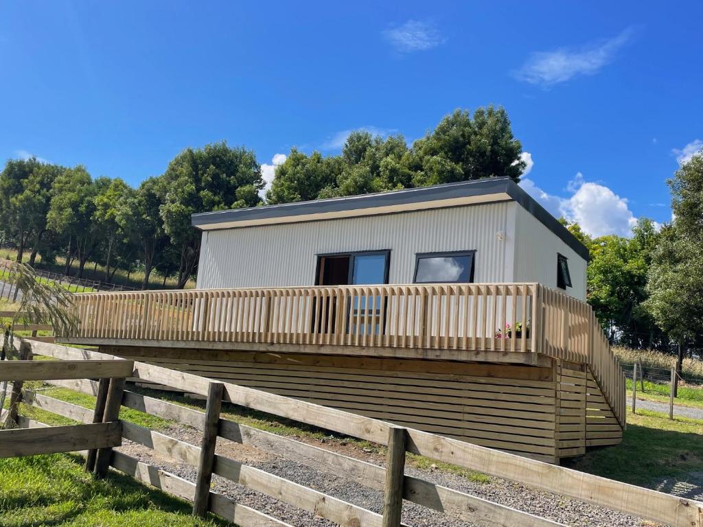 a tiny house with a wooden fence around it at Rural Getaway in Thames