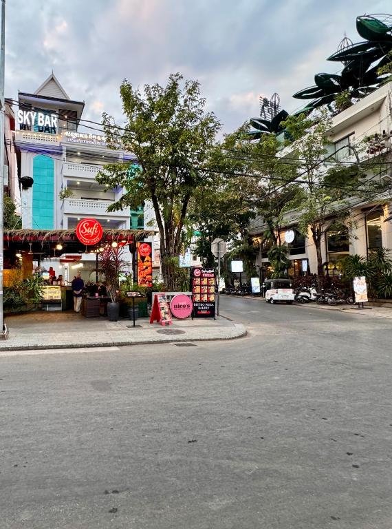 an empty street in a city with shops and buildings at Nico’s Hotel and SkyBar in Siem Reap