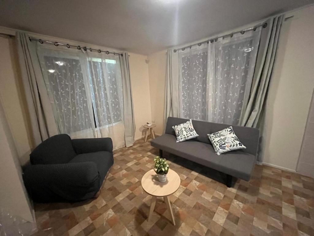 a living room with a couch and a table at Cabañas Sol y Mar in Puerto Montt