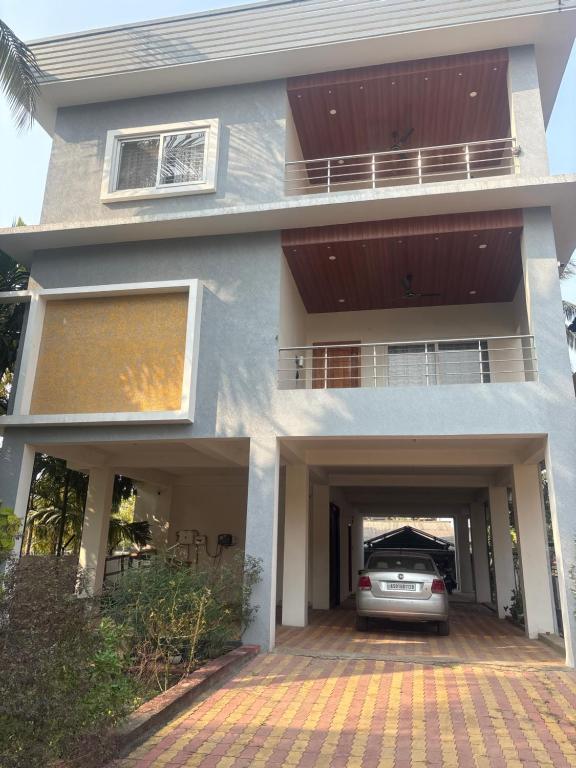 a house with a car parked in the garage at Deepalaya in Guwahati