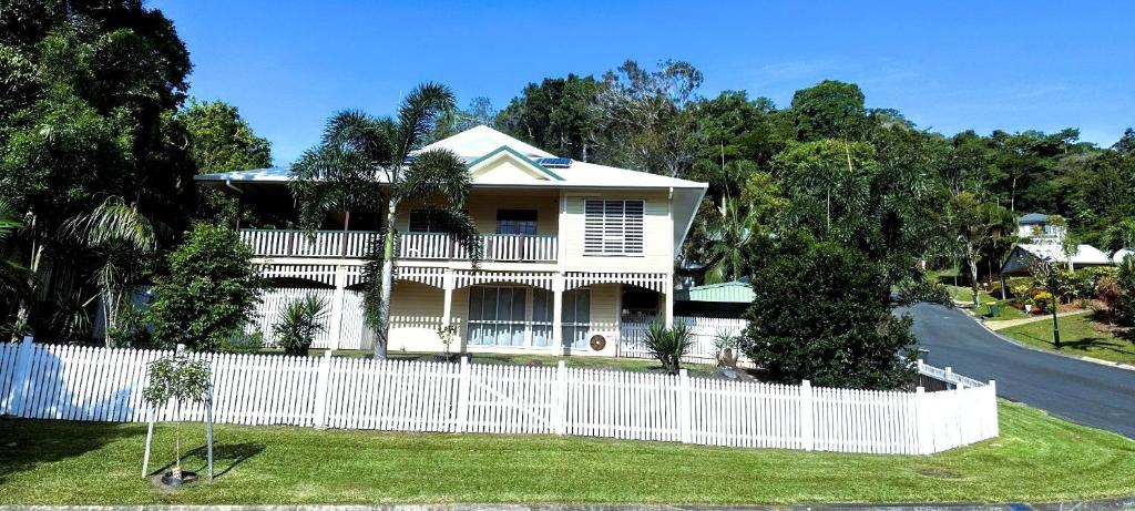 a white fence in front of a house at Kalani - The Heavens View House in Freshwater