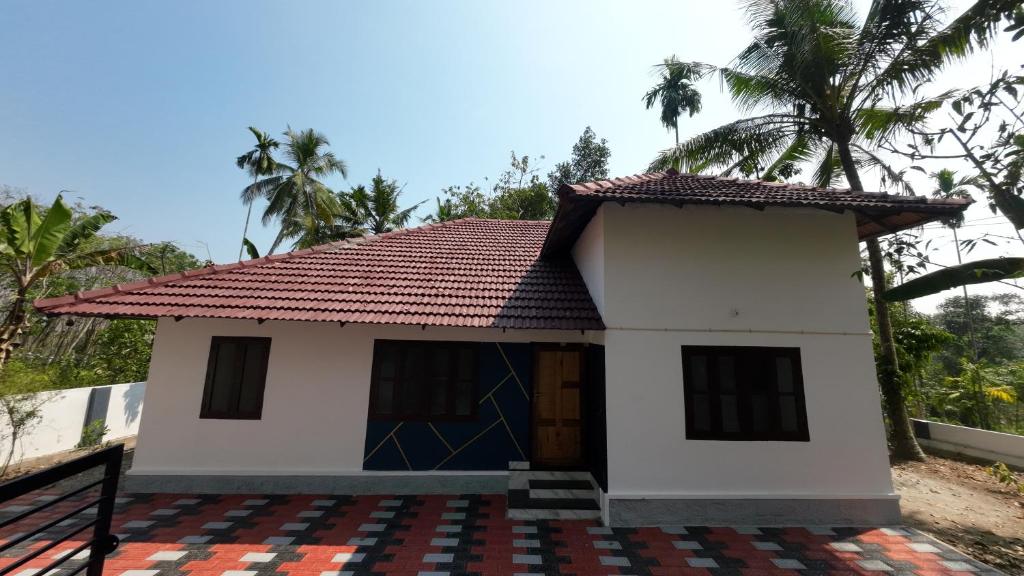 a small house with a red roof at Haven roots in Trivandrum