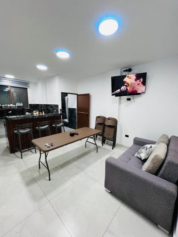 a living room with a couch and a table at Cesar Palace Departamento in Cojimíes