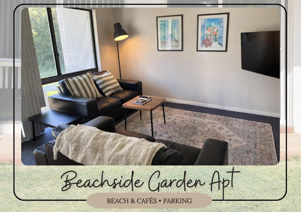 a living room with a couch and a table at Beachside Garden Apt Beach Scarborough with Parking in Perth