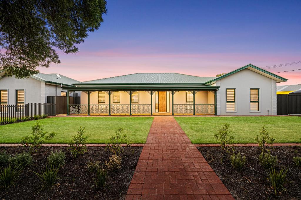 a large white house with a green roof at Shining House Villa B in Tanunda