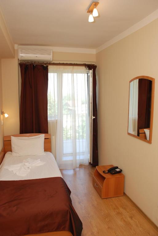 Postel nebo postele na pokoji v ubytování Hotel Liliacul