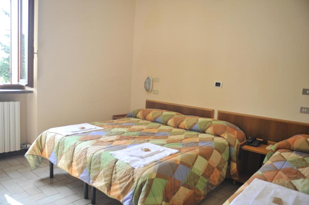 Łóżko lub łóżka w pokoju w obiekcie Hotel Fontemaggio