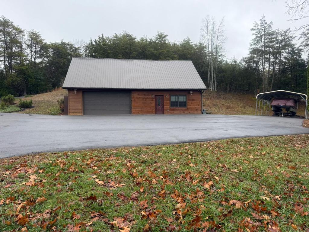 a building with a parking lot in front of it at Small Cabin Over Garage with lake access and small dock in Sevierville
