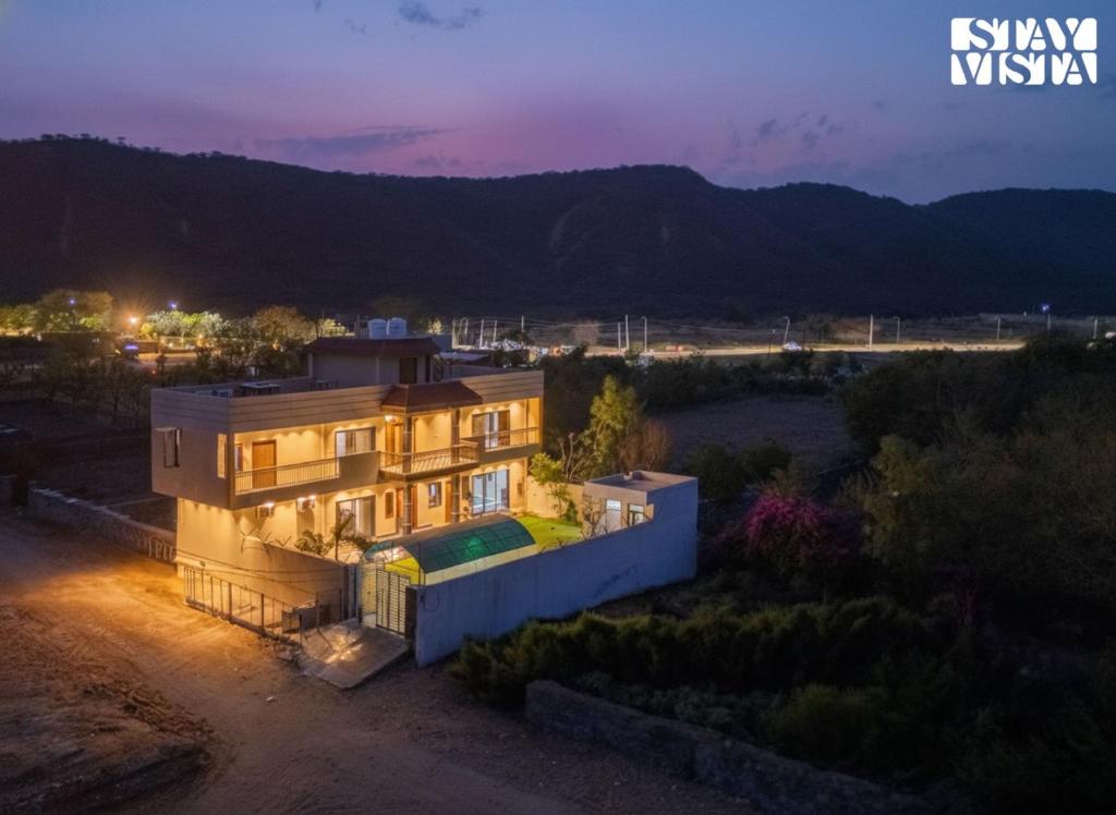 an aerial view of a house at night at StayVista at The Binclave with Jacuzzi, Pvt Indoor Pool, Bar & Projector in Jaipur