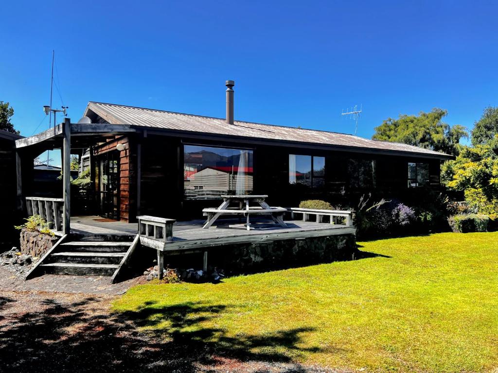 a house with a picnic table in front of it at Cosy Corner Te Anau in Te Anau