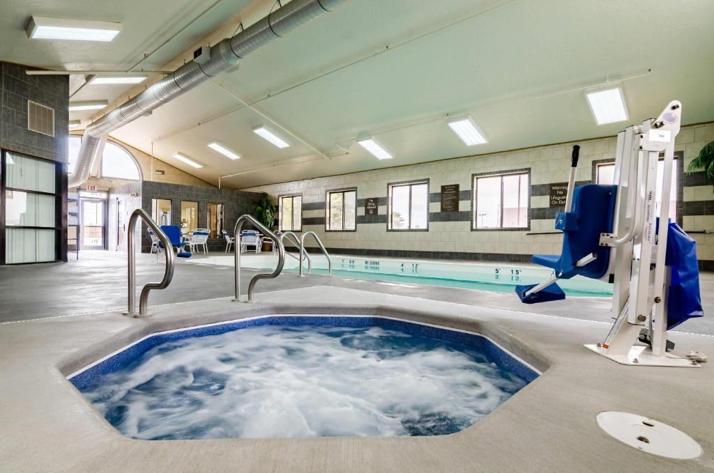 a swimming pool with a hot tub in a building at Quality Inn & Suites Colby in Colby
