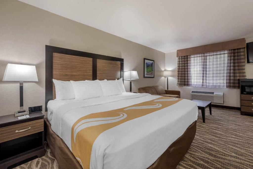 a hotel room with a large bed and a desk at Quality Inn & Suites South Fork - Wolf Creek in South Fork