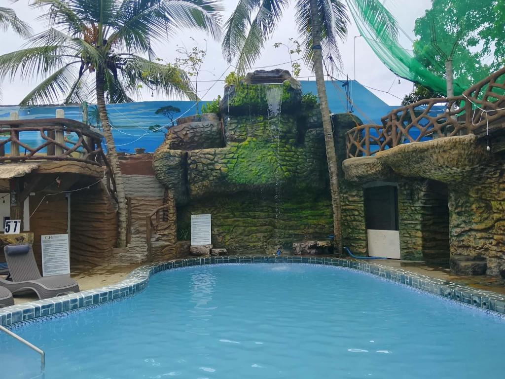 a large swimming pool in front of a resort at Coastal Haven Resort in Siquijor