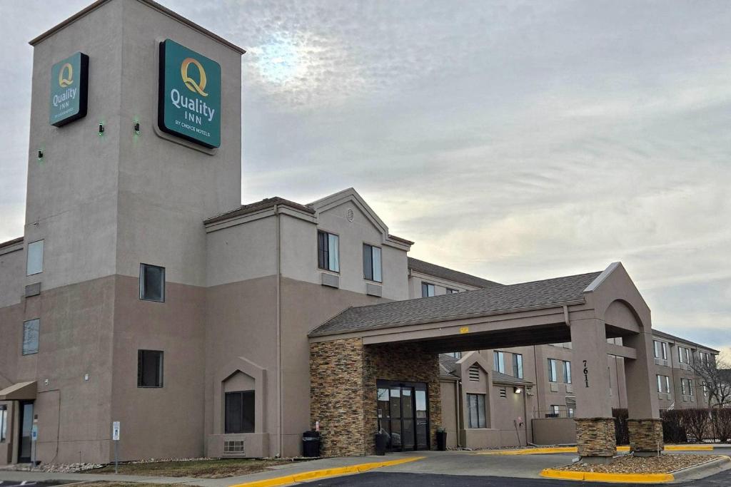 a hotel with a sign on top of a building at Quality Inn Kansas City International Airport in Kansas City