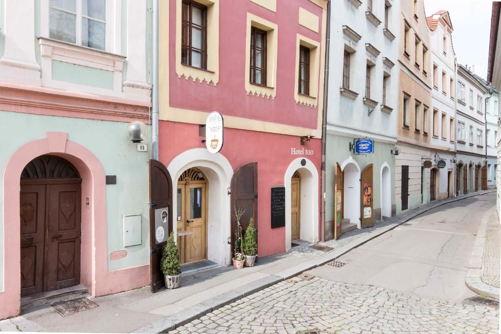 an empty street in a city with colorful buildings at Hotel 100 in Pardubice