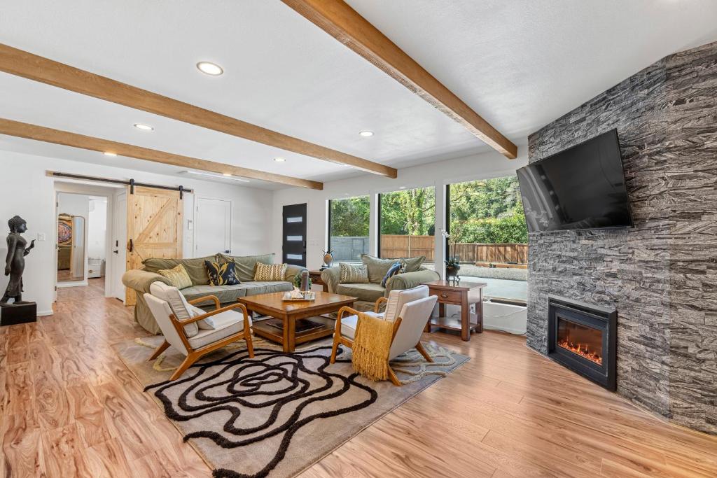 a living room with a stone wall at Redwoods Luxury Sanctuary in Redway