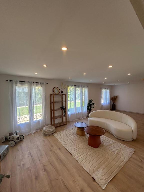 a large living room with a large bed and a rug at A Orléans proche orée de sologne in Orléans