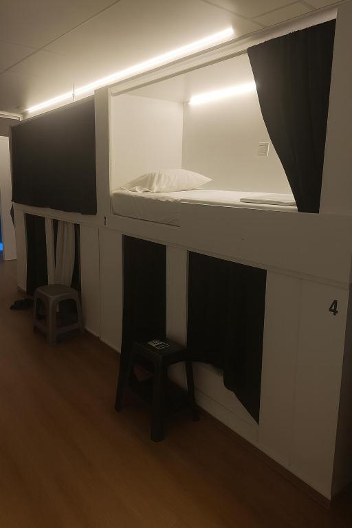 a room with a bed with a mirror and a stool at Cozy Nook in Valencia
