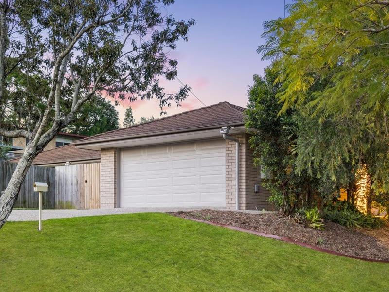 a house with a garage in a yard at 4 bedrooms with queen sized bed each room in Riverview