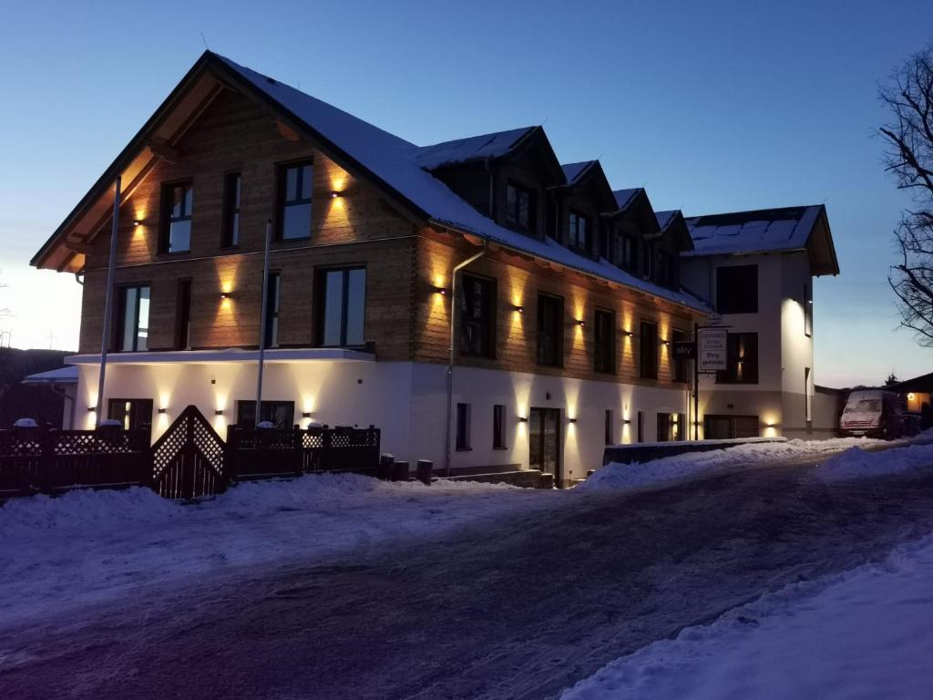 a large house in the snow at night at Landhotel Berggaststätte Bickenriede in Anrode