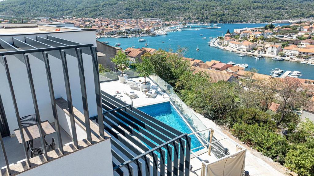 a balcony with a pool and a view of a river at Villa Lana by Villas Guide in Vela Luka