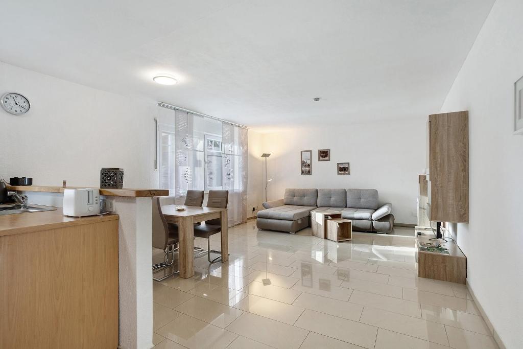 a kitchen and living room with a couch and a table at Ferienwohnung Gaberle in Balve
