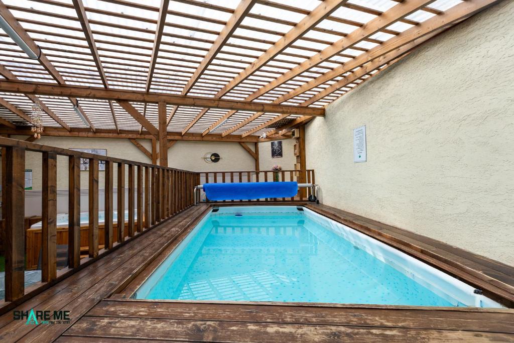 a swimming pool with a pergola and an indoor swimming poolvisor at וילה לה מונטנייה in Dāliyat el Karmil