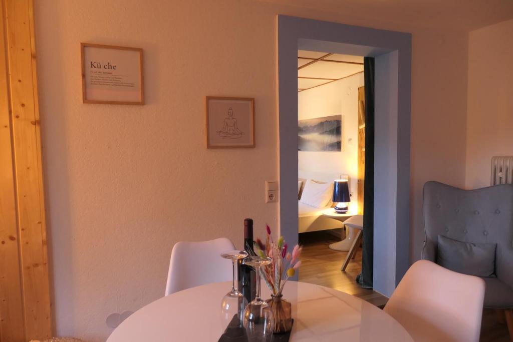 a dining room with a white table and white chairs at theBlackwood in Todtnauberg
