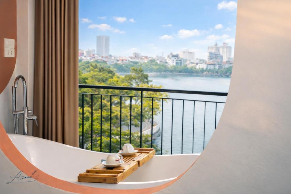 a bath tub in a room with a view at AimeeHouse - Trích Sài in Hanoi
