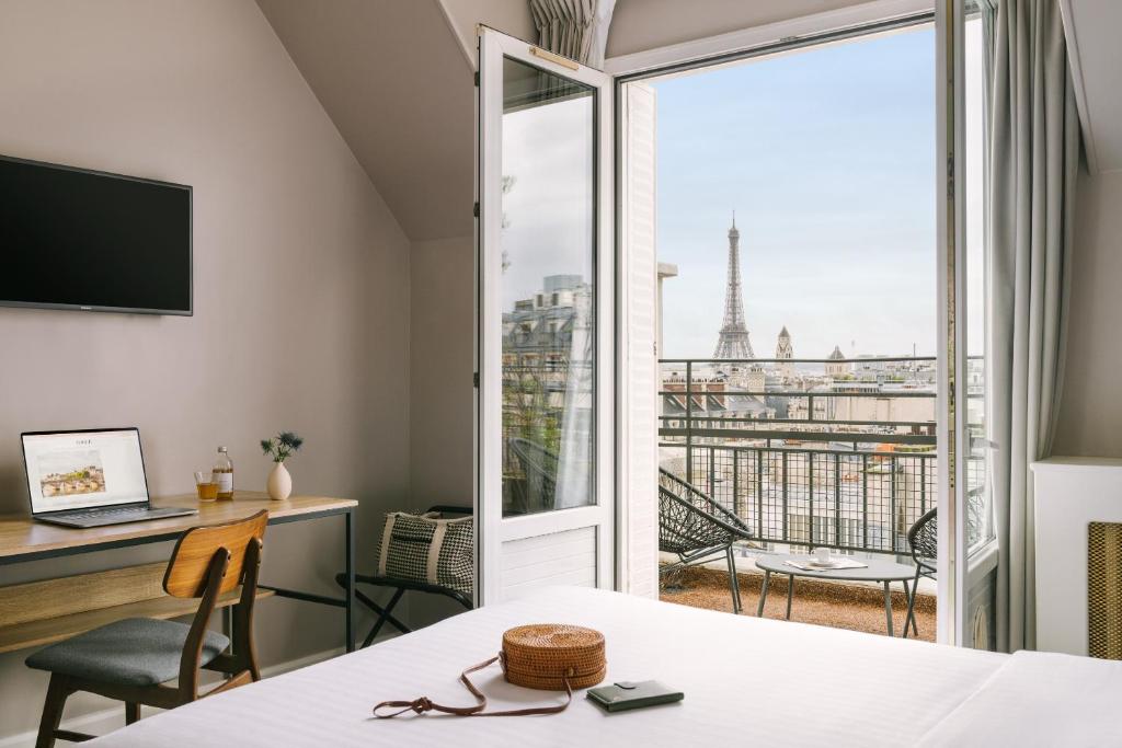 a room with a view of the eiffel tower at Hôtel Atala Champs Elysees in Paris