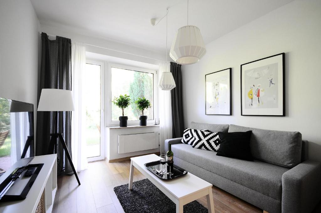 uma sala de estar com um sofá e uma mesa em A Place Like Home Apartamenty Wiewiorcza em Gdansk