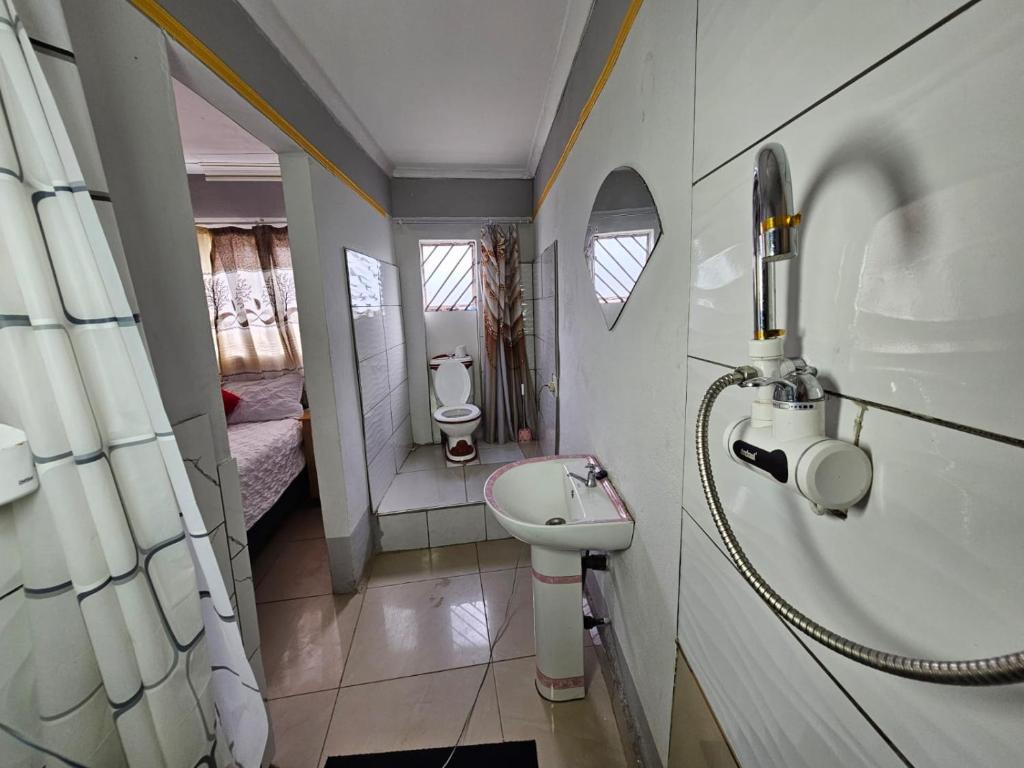 a small bathroom with a sink and a toilet at Turfloop guest house in Ga-Mothapo