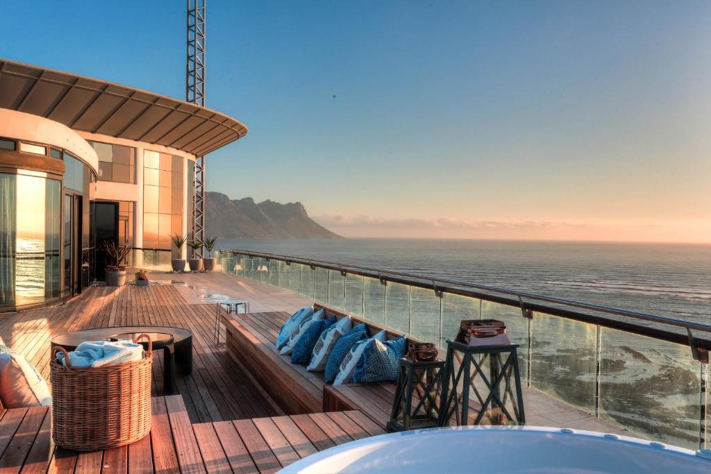 a view of the ocean from the balcony of a house at Ocean View Penthouse in Strand
