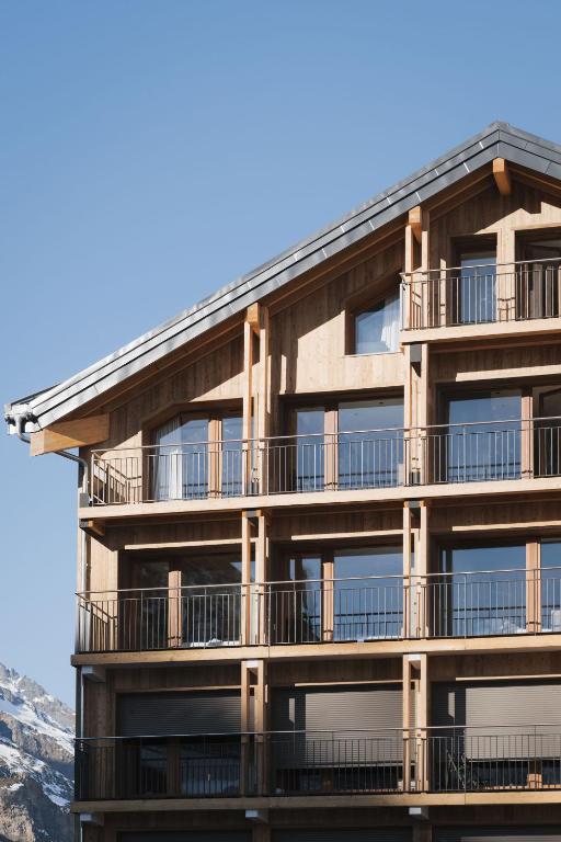 an apartment building with balconies on the side of it at Résidence Freddie in Tignes