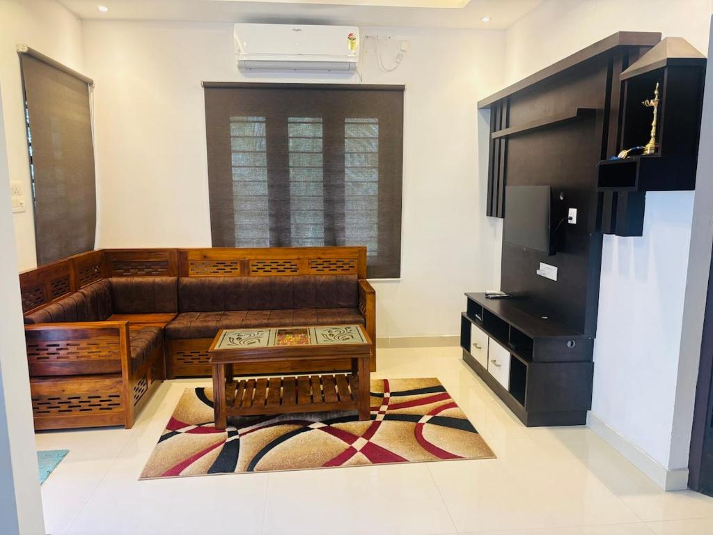 a living room with a couch and a tv at Love shore in Cochin