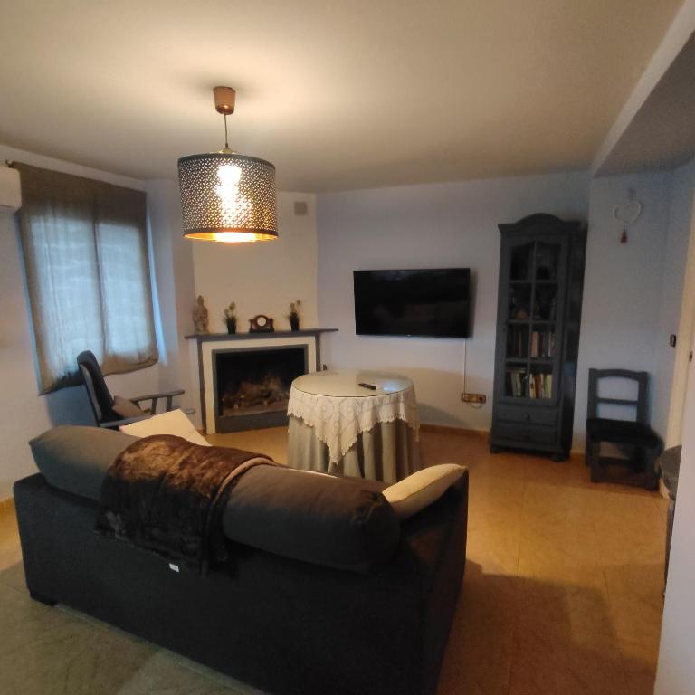 a living room with a couch and a fireplace at Kalma Casa Luisa in Cazorla