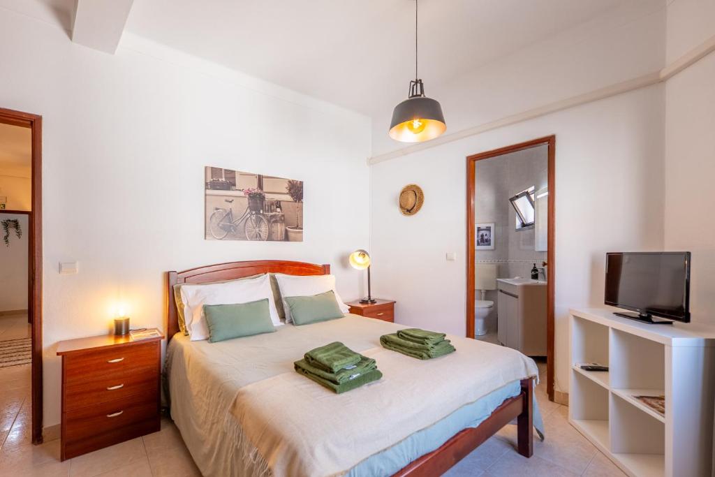 a bedroom with a bed with two pillows on it at Hospedaria Portuguesa in Alpiarça