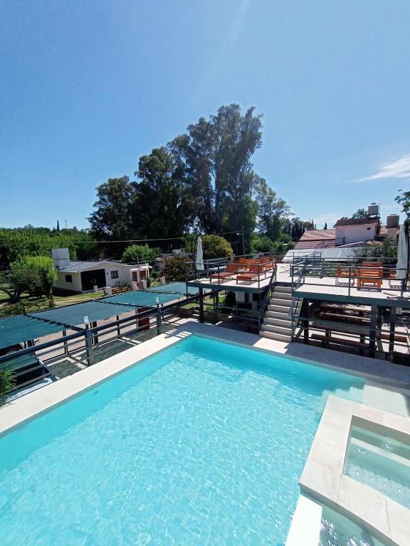 a large swimming pool with tables and benches at La posta del vasco in Tanti