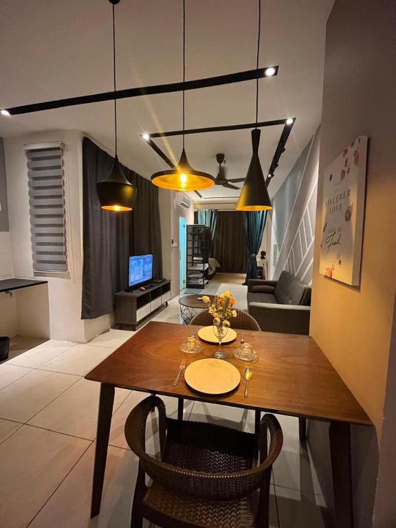 a dining room with a table and a living room at Skyhaus Homestay in Penampang