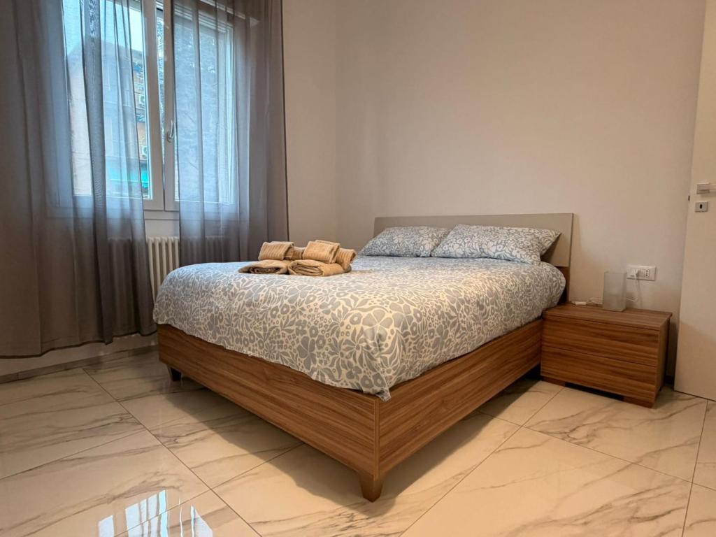 a bedroom with a bed and a large window at Il Piano B in Molinella