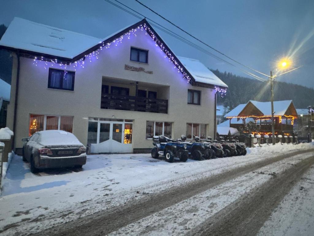 a group of snowmobiles parked in front of a building at Casa Andu in Dâmbovicioara