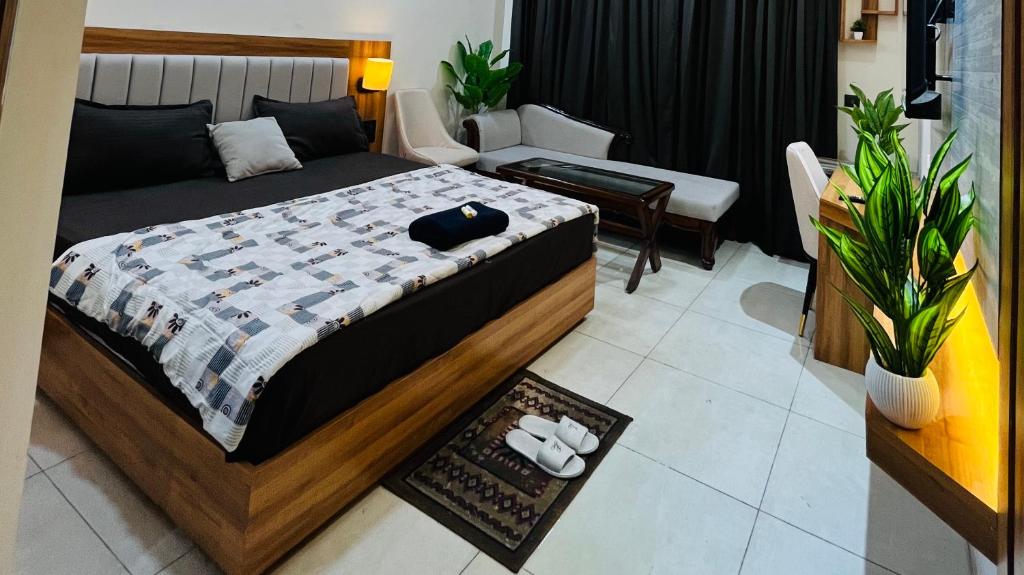 a bedroom with a bed and a living room at Moon Path Stay in Nalmatha