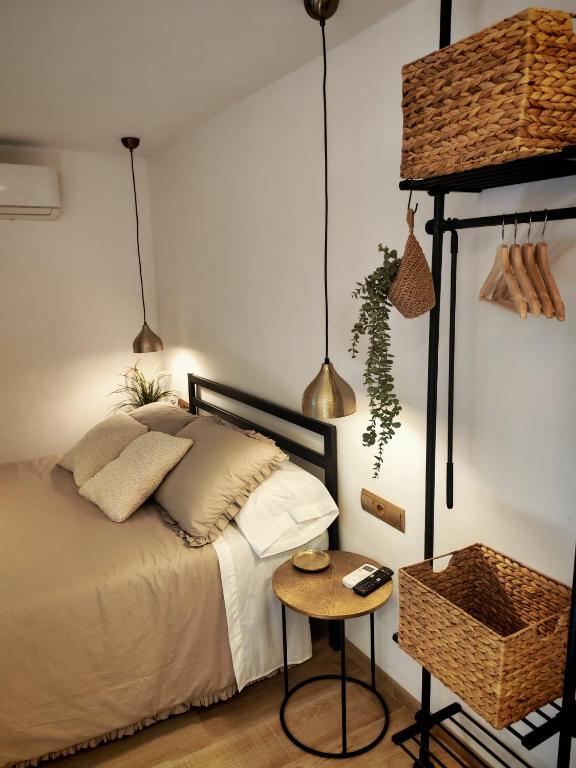 a bedroom with a bed and a table and pendant lights at Ca l'Eli Loft in Montblanc