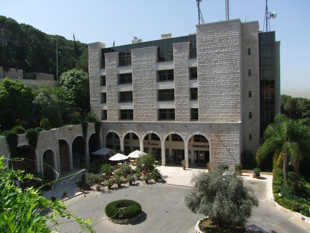 a large building with a courtyard in front of it at Rabieh Guest house in Rabieh