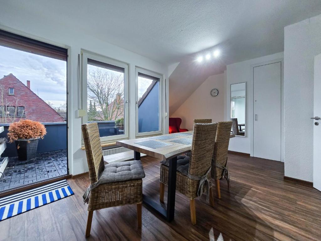 a dining room with a table and chairs at Alpha Apartments in Datteln