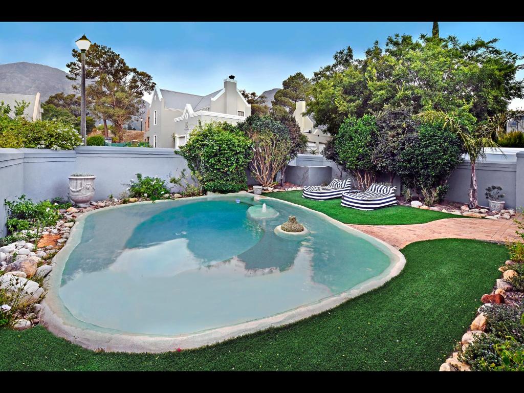 a large swimming pool in the yard of a house at Sunflower Villa in Franschhoek in Franschhoek