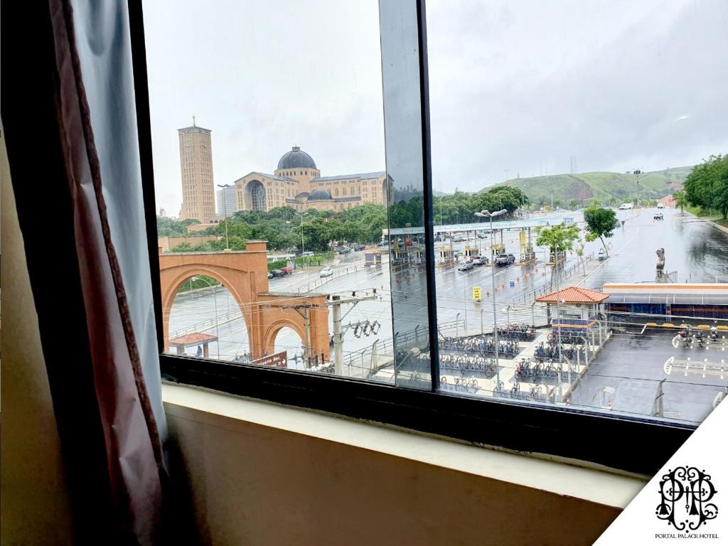 a view of a city from a window at Portal Palace Hotel in Aparecida
